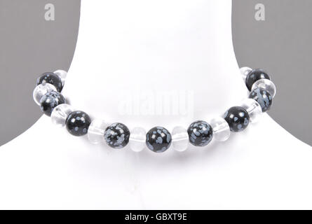 Rock crystal and snowflake obsidian chain on bust Stock Photo