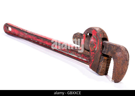 Studio shot left full front view of old neglected rusty well used red monkey wrench spanner on white background Stock Photo