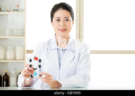 asian female scientist Examining the building blocks of life with molecular model in laboratory Stock Photo