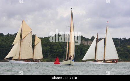 Lutine (centre) leads Rebecca of Vineyard Haven (39) and Eileen II round the Norris Castle mark in Osborne Bay during racing in the British Classic Yacht Club regatta on The Solent near Cowes, Isle of Wight. Stock Photo
