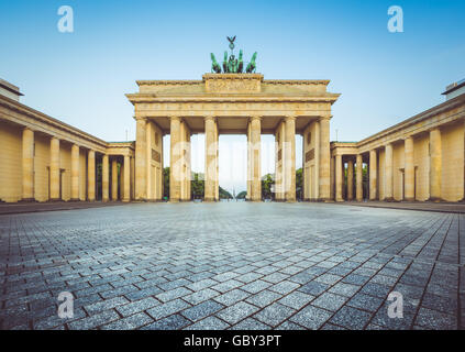 Classic view of famous Brandenburg Gate at sunrise with retro vintage filter effect, central Berlin, Germany Stock Photo