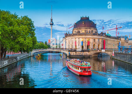 Beautiful view of Museumsinsel (Museum Island) with famous TV tower and excursion boat on Spree river in beautiful evening light Stock Photo