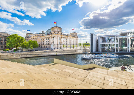 Panoramic view of Berlin government district with excursion boat on Spree river passing famous Reichstag building, Germany Stock Photo