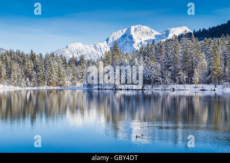 Idyllic winter wonderland with crystal clear mountain lake in the Alps on a cold sunny day Stock Photo