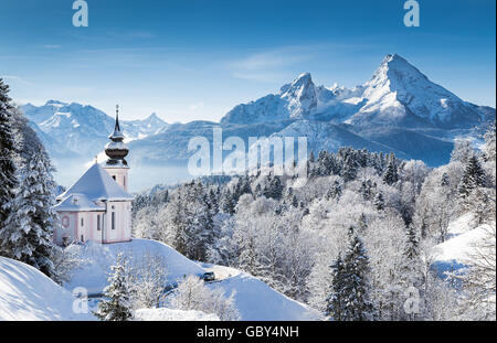 Idyllic winter wonderland in the Alps with pilgrimage church of Maria Gern and famous Watzmann mountain summit, Bavaria, Germany Stock Photo