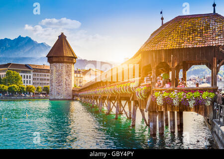 Historic city center of Lucerne with famous Chapel Bridge and Mount Pilatus at sunset, Switzerland Stock Photo