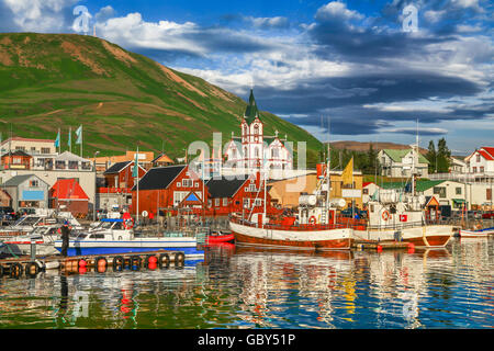 Beautiful view of the historic town of Husavik in golden evening light at sunset, north coast of Iceland Stock Photo