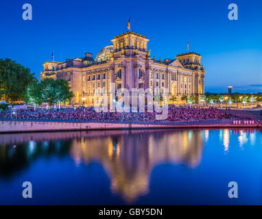 Classic view of famous Reichstag building reflecting in Spree river in twilight during blue hour at dusk, Berlin, Germany Stock Photo