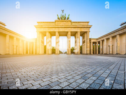 Classic view of famous Brandenburg Gate in beautiful golden morning light at sunrise, central Berlin, Germany Stock Photo