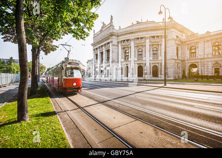 Wiener Ringstrasse with historic Burgtheater (Imperial Court Theatre) and traditional  electric tram at sunrise, Vienna, Austria Stock Photo