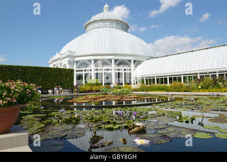 Enid A. Haupt Conservatory and pond with water lilies, New York Botanical Garden, Bronx, NY Stock Photo