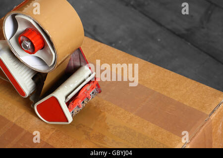 Taping box with a tape dispenser Stock Photo
