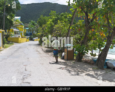 dh Cane Garden Bay TORTOLA CARIBBEAN Local man walking beach main road Route 1 roads people leeward islands Stock Photo