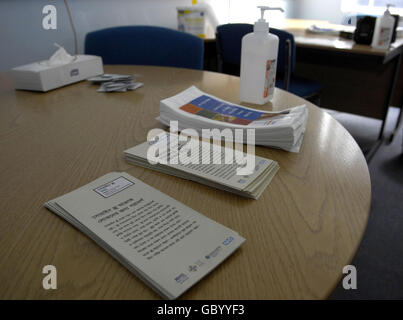 Advice leaflets on display at Mile End Hospital's anti-viral collection point, London. Stock Photo