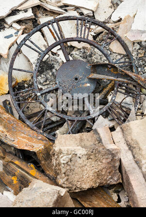 Destroyed personal property after a house fire. Clock in ruins of burned home after a natural disaster wildfire. Stock Photo