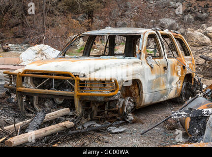 Burned automobile after a natural disaster wildfire. Personal property destroyed in a forest fire. Stock Photo