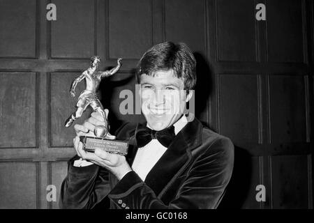 Liverpool's Emlyn Hughes shows off his 1976-77 Footballer of the Year trophy Stock Photo