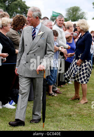 The Prince of Wales and the Duchess of Cornwall talk to wellwishers during a visit to the Sandringham Flower Show on The Queen's estate in Norfolk. Stock Photo