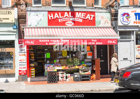 Store front view of Halal grocery and meat shop in London England with produce displayed on the pavement Stock Photo
