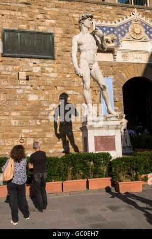 Copy of the David statue by Michaelangelo in the Piazza della Signore, and shadow cast on the wall behind, Florence, Tuscany, It Stock Photo