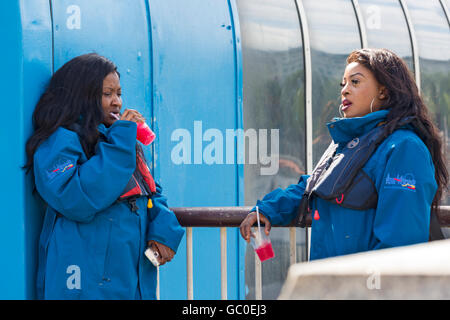Rib Tours workers stopped for a drink along the Embankment, London in July Stock Photo