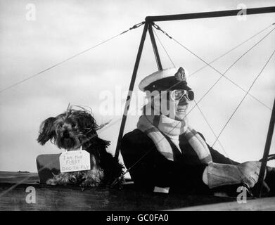 Actor Jeremy Lloyd, filiming with Baxter the Yorkshire Terrier, who belongs to Ken Annakin, director of the film Those Magnificent Men in Their Flying Machines, a comedy based around The Daily Mail Circuit of Britain Air Race held at Brooklands in 1911. Stock Photo