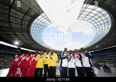 Usain Bolt stands in the middle as the Jamaican relay team collect their Gold Medals from the 4x100 men's relay in which Great Britain (right) took the Bronze medal during the IAAF World Championships at the Olympiastadion, Berlin. Stock Photo