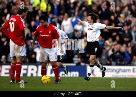 Derby County's Grzegorz Rasiak celebrates scoring as Nottingham Forest's Andy Reid and Gareth Taylor stand dejected Stock Photo