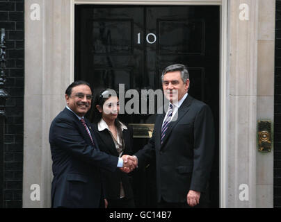 Prime Minister Gordon Brown shakes hands with Pakistani president Asif Ali Zardari while his daughter Asifa Bhutto Zardari looks on, at 10 Downing Street, London. Stock Photo