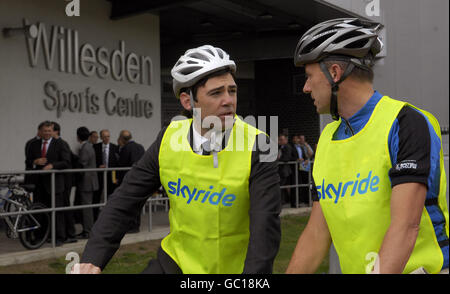 Health Secretary Andy Burnham (left) speaks with Andy Cook from British Cycling, as they take part in a Sky Bike4Life event at Willesden Sports Centre in north London, after Burnham made a speech calling for a more active lifestyle for the UK. Stock Photo