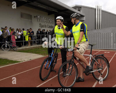 Health Secretary Andy Burnham (left) speaks with Andy Cook from British Cycling, as they take part in a Sky Bike4Life event at Willesden Sports Centre in north London, after Burnham made a speech calling for a more active lifestyle for the UK. Stock Photo