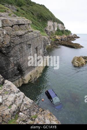 A general view of the scene in Benllech, Anglesey, where 11-year-old Paige Dean cheated death after jumping from her grandfather's car (shown in sea) before it fell 50ft off a cliff edge and landed in the sea. Stock Photo