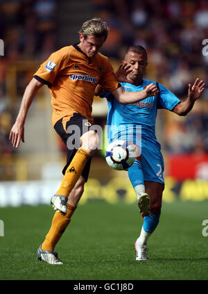 Soccer - Barclays Premier League - Wolverhampton Wanderers v Hull City - Molineux Stadium. Wolves' Richard Stearman is challenged by Hull City's Kamel Ghilas during the Barclays Premier League match at Molineux, Wolverhampton. Stock Photo