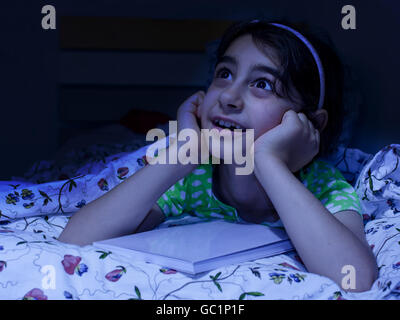 little girl laying in bed daydreaming,   before sleep Stock Photo