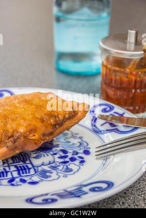 Crispy deep fried spring roll on a chinese plate, served with spicy red sauce Stock Photo