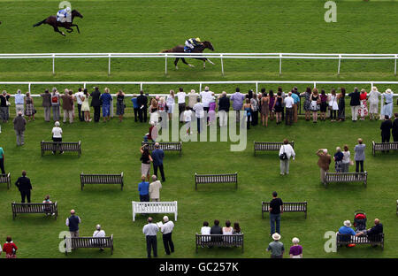 Pounced ridden by Ryan Moore (above, centre) on their way to victory in the Don Deadman Memorial E.B.F. Maiden Stakes at Newbury Racecourse, Berkshire. Stock Photo