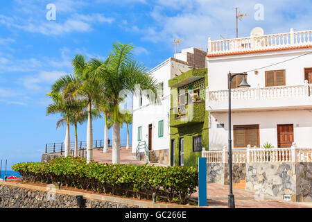 Palm trees on promenade in Alcala town with typical Canarian architecture on coast of Tenerife, Canary Islands, Spain Stock Photo