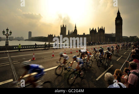 Cyclist's ride over Westminster Bridge in front of the Houses of Parliament with the bunch in the final Tour of Britain stage in London, in support of the Prostate Cancer Charity. Stock Photo