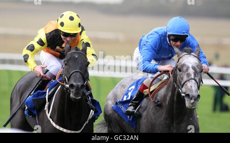 Chock A Block ridden by Frankie Dettori (r) leads from Drill Sergeant ridden by Joe Fanning to win the Haafhd Godolphin Stakes during the Cambridgeshire Meeting at Newmarket Racecourse. Stock Photo