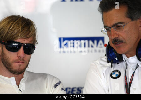 BMW Sauber's Nick Heidfeld (left) with BMW's Motorsport Director Mario Theissen, in the pits during first practice at the Monza Circuit, Italy Stock Photo