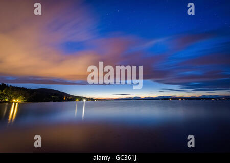 Long exposure of clouds moving over Lake Winnipesaukee at night, at Ellacoya State Park, in Laconia, New Hampshire. Stock Photo