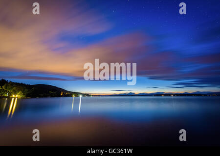 Long exposure of clouds moving over Lake Winnipesaukee at night, at Ellacoya State Park, in Laconia, New Hampshire. Stock Photo
