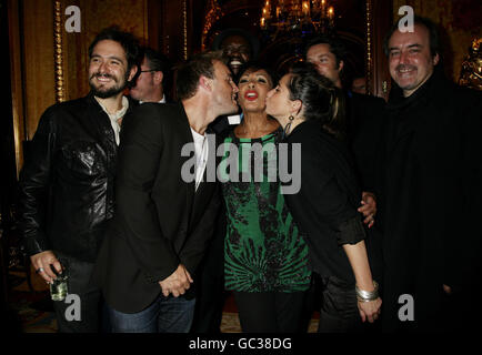 Dame Shirley Bassey, centre, with the songwriters who have contributed to her new album 'The Performance' (L-R) Tom Baxter, Richard Hawley (partially obscured), Gary Barlow, David McAlmont (background), KT Tunstall, Rufus Wainwright and producer David Arnold, during the album playback party, at The Ritz hotel in, central London. Stock Photo
