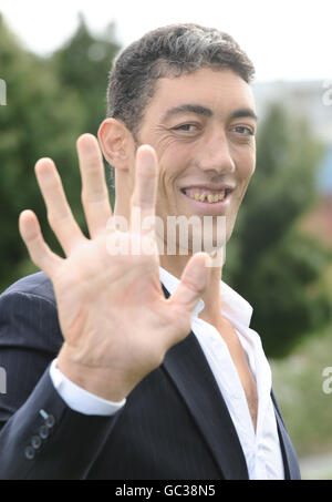 Sultan Kosen, from Turkey, is announced as the Guinness World Records Tallest Man standing at 8ft 1, and the record for the largest hands at 27.5cm, seen in Potters Field in London. Stock Photo