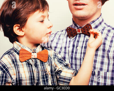 father with son in bowties on white background, casual look Stock Photo