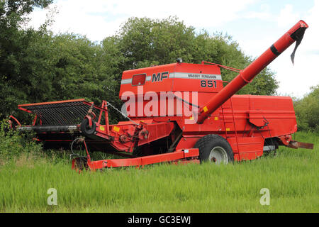 A Massey Ferguson 851 pull-type combine. On a farm in Alberta, Canada. Stock Photo