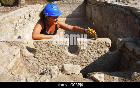 Rose Ferraby from the University of Southampton working on a three seat communal toilet discovered at the site of the ancient port of the Roman Empire near Rome, Italy. Stock Photo