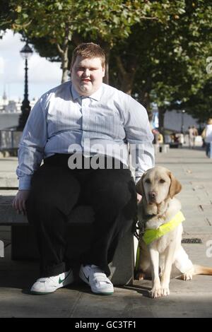Sidney Tambin 18 from Durham with his Guide Dog Jamie, one of the first four people under sixteen to qualify for a Guide Dog in the UK who were united for the first time on London's Southbank. Press Association Photo. Date Sunday 04 October 2009. Over 18,000 blind and partially sighted youngsters are missing out on crucial help with mobility, independence and life skills according to research by Guide Dogs. Picture Credit should read David Parry/ PA Stock Photo