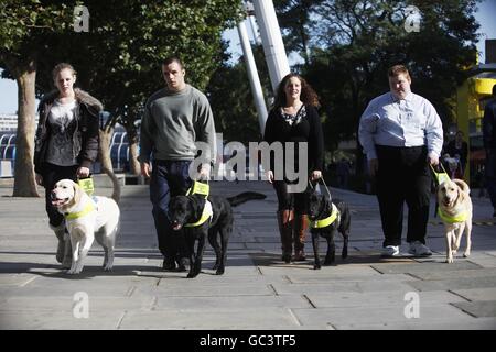 The first four people under sixteen to qualify for a Guide Dog in the UK who were united for the first time on London's Southbank. L-R Kirsty Meinhardt 15 with Websta, Brad Ranson 16 with Lance, Andrea Cooper 18 with Cara and Sidney Tamblin 18 with Jamie. Press Association Photo. Date Sunday 04 October 2009. Over 18,000 blind and partially sighted youngsters are missing out on crucial help with mobility, independence and life skills according to research by Guide Dogs. Picture Credit should read David Parry/ PA Stock Photo