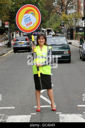 TV presenter Lorraine Kelly stops the traffic at the Abbey Road pedestrian crossing, in London, during the launch of the Lollipop Person of the Year Awards 2009. Stock Photo